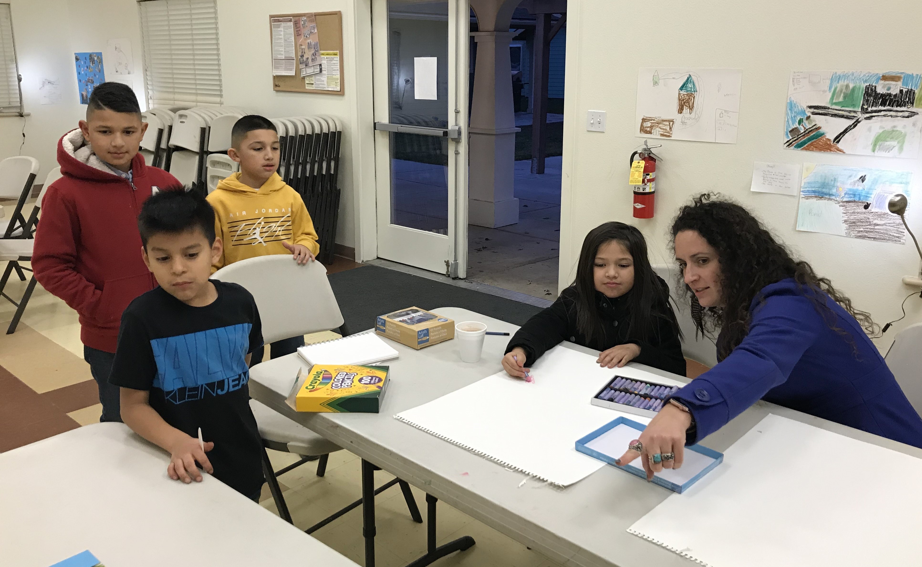 Dr. Kelton and participants create and discuss scientific artwork at a community art show.
